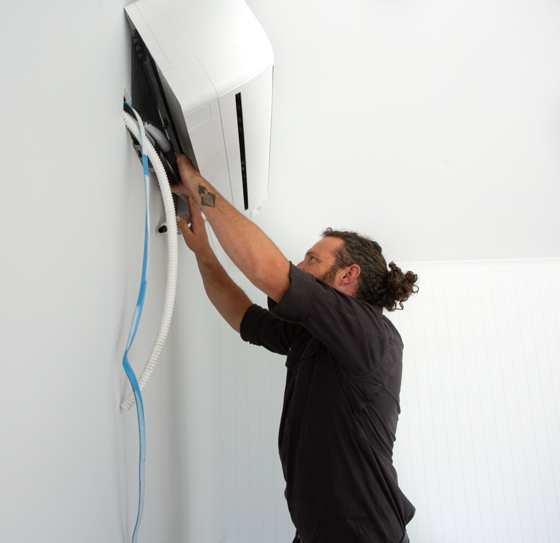 Coalfields Climate Control technician installing a split system air conditioner